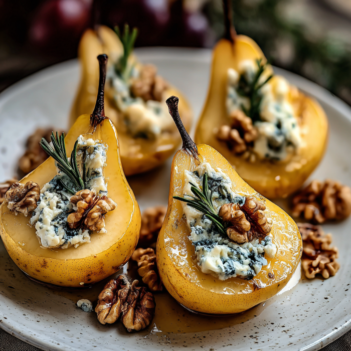 A plate of stuffed pears with blue cheese and walnuts.
