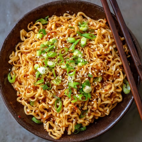 A bowl of Dragon Noodles with vegetables and sauce.