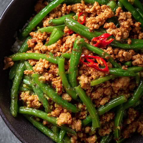 A bowl of Asian Chili Ground Turkey & Green Bean Bowls is filled with a delicious mixture of ingredients.