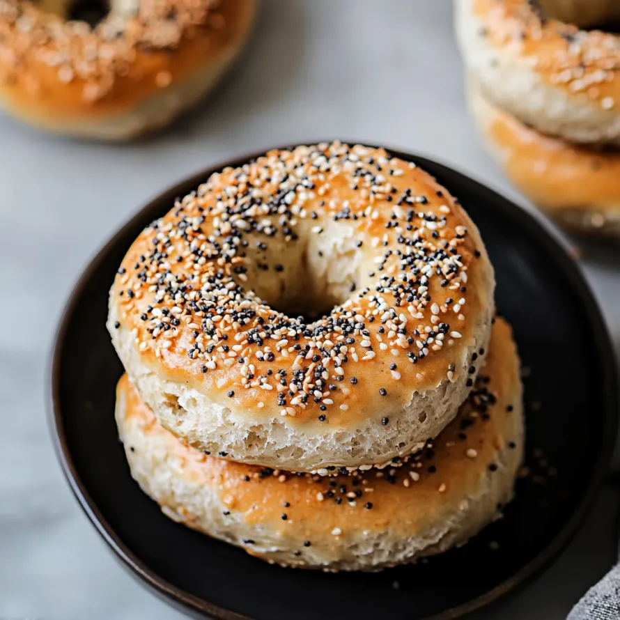 A plate of bagels with sesame seeds.