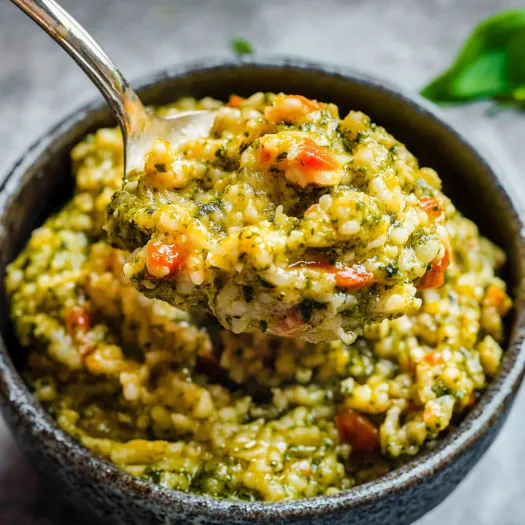 A spoon is in a bowl of food.