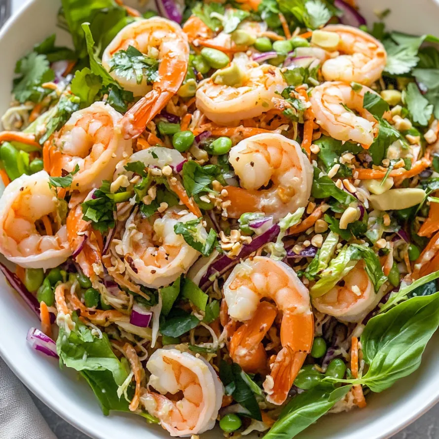A bowl of shrimp salad with peppers and greens.