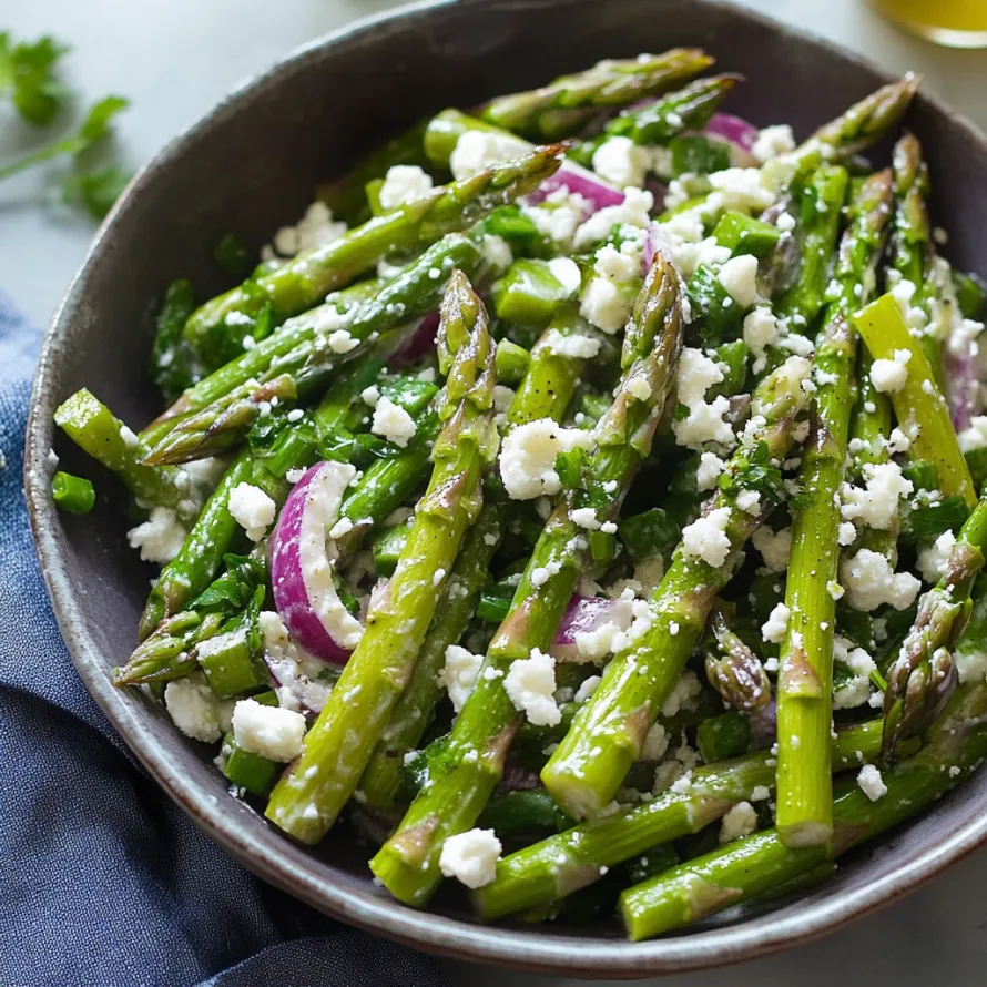 A bowl of asparagus and feta cheese.