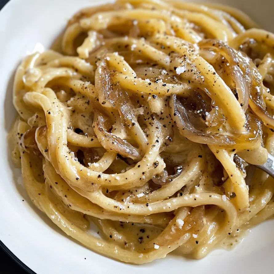 A bowl of pasta with onions.