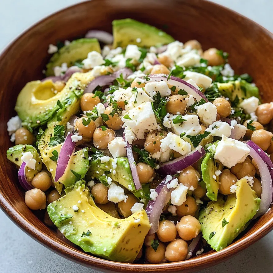 A bowl of food with avocado, chickpeas, and cheese.