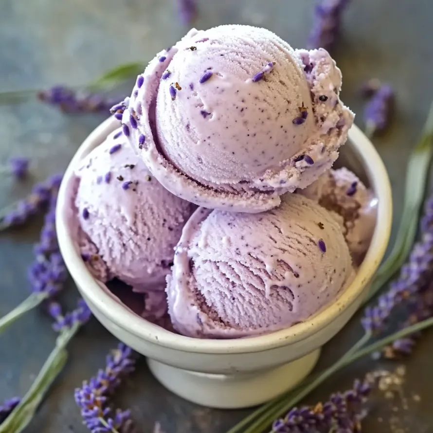 A bowl of purple ice cream with lavender flowers.