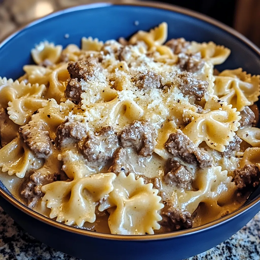 A bowl of pasta with meat and cheese.