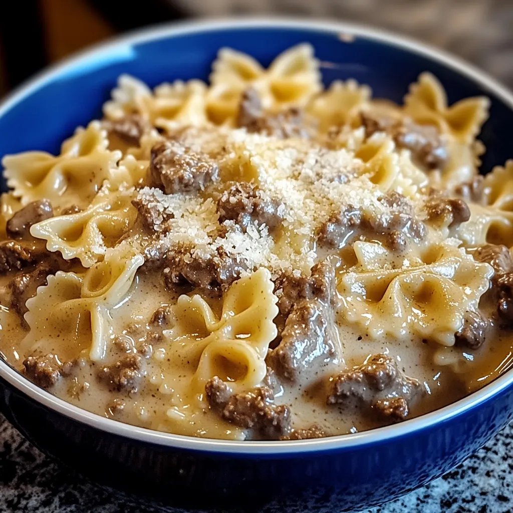 A bowl of pasta with meat and cheese.
