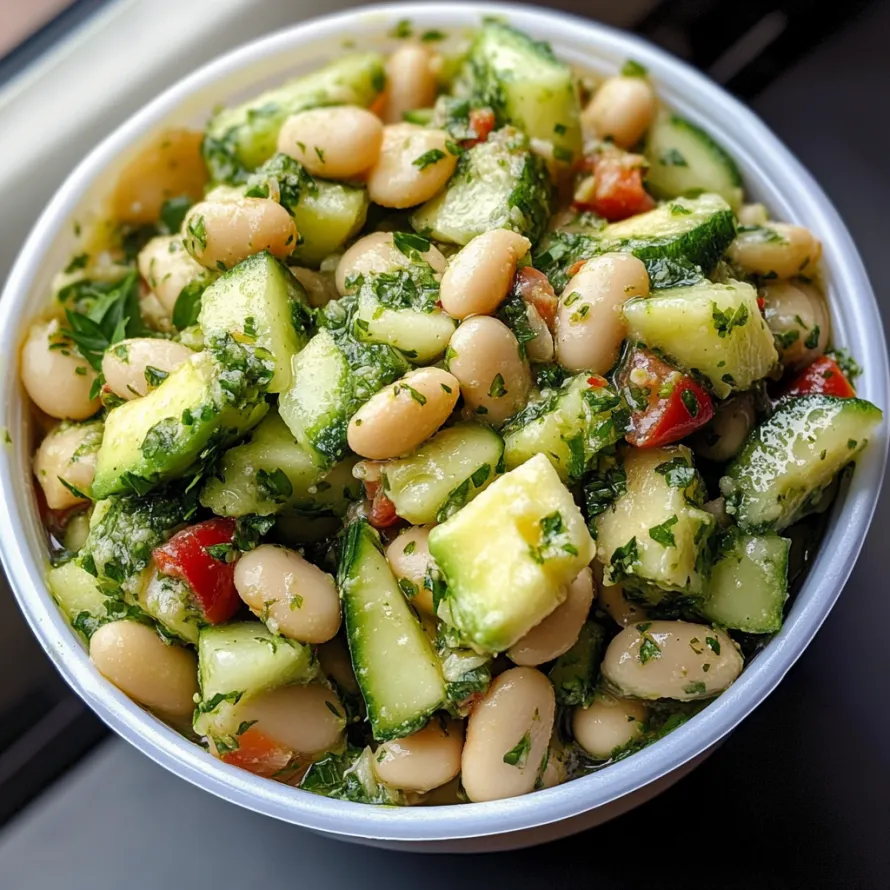 A bowl of vegetables with green beans, tomatoes, and cucumbers.