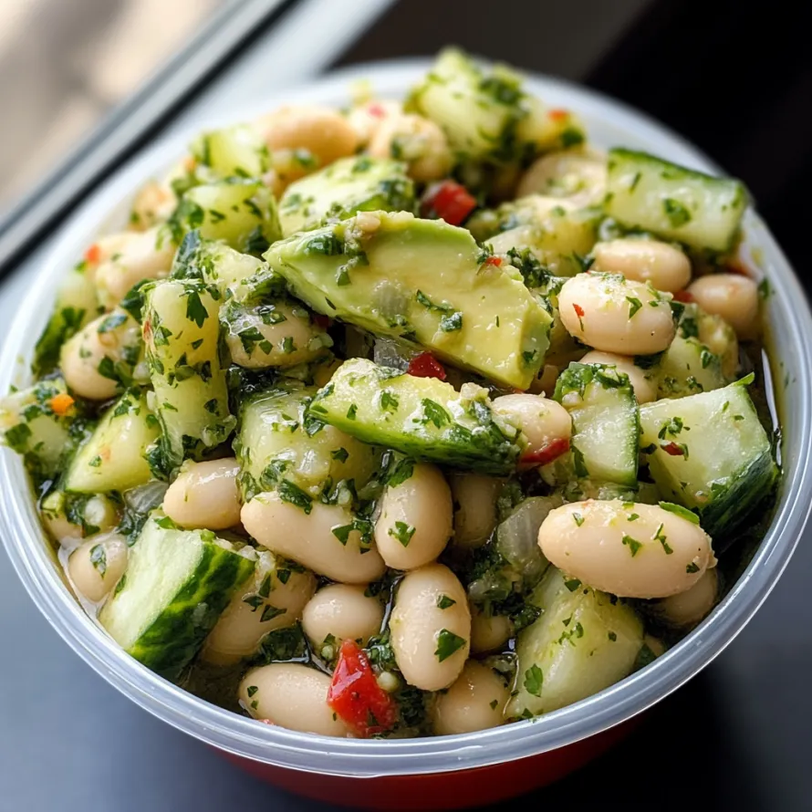 A bowl of vegetables including beans, cucumbers, and avocado.