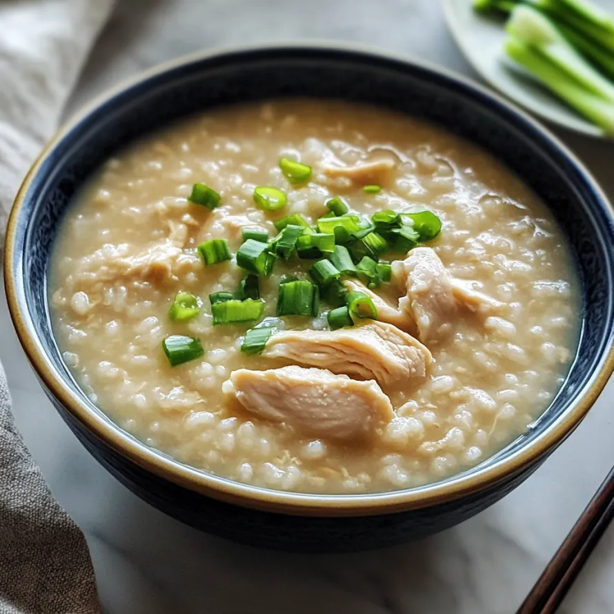 A bowl of soup with chicken and green onions.