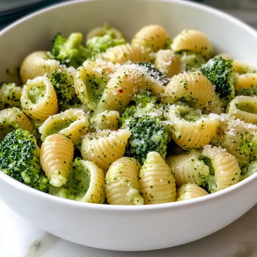 A bowl of pasta with broccoli and cheese.