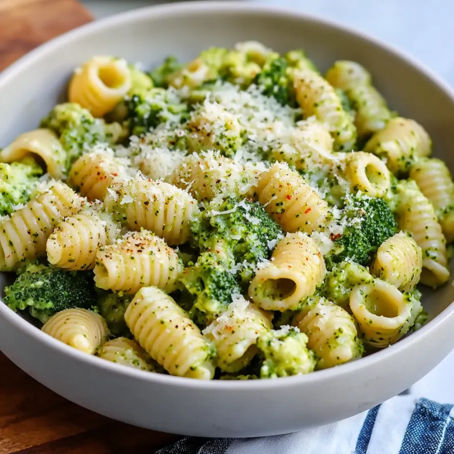 A bowl of pasta with broccoli and cheese, making a light and healthy meal.