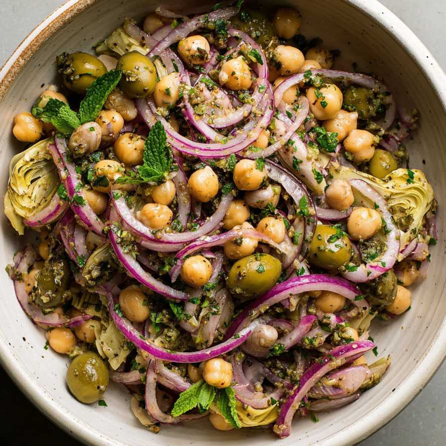 A bowl of Marinated Za'atar Bean Salad is displayed, featuring a mix of vegetables and beans.