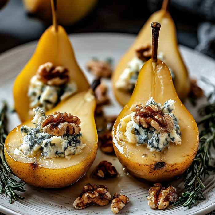 A plate of pears with walnuts and blue cheese on top.