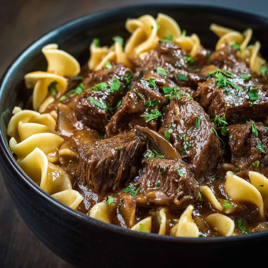 A bowl of beef and noodles, with a close-up of the meat and noodles.
