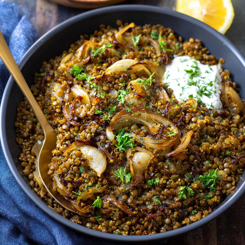 A bowl of vegetable stew with onions, garlic, and lemon.