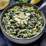 A bowl of rice with cheese and spinach.
