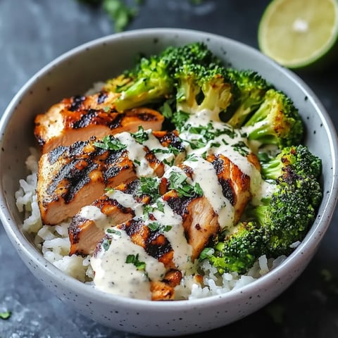 A bowl of food with rice, broccoli, and meat.