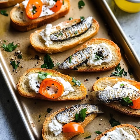 A tray of bread with tomatoes and white cheese.