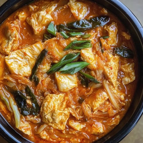 A bowl of food with a green vegetable on top.