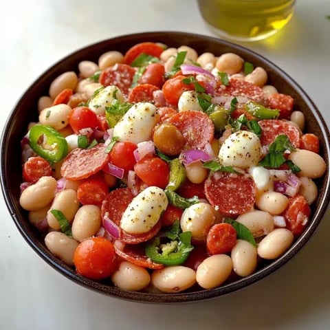 A bowl of food with tomatoes, beans, peppers, and cheese.