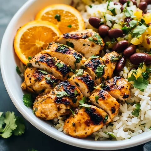 A bowl of rice, beans, and chicken.