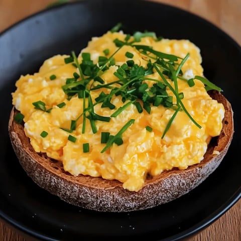 A plate of food with a slice of bread and eggs.