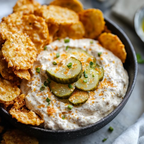 A bowl of Fried Pickle Ranch Dip with a generous amount of pickles and ranch dressing.