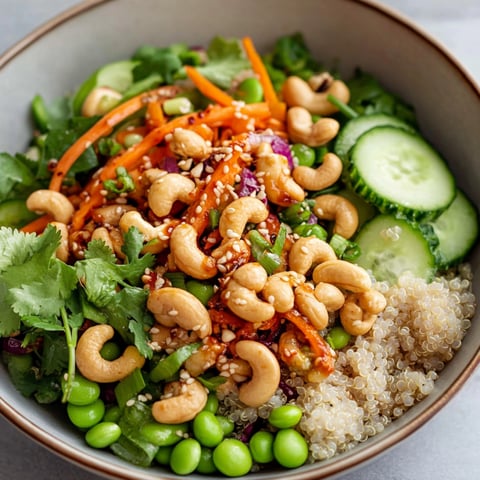 A bowl of Cashew Crunch Edamame Salad, filled with a variety of vegetables and nuts.