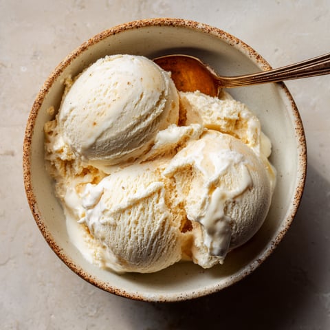 A bowl of ice cream with a spoon in it.