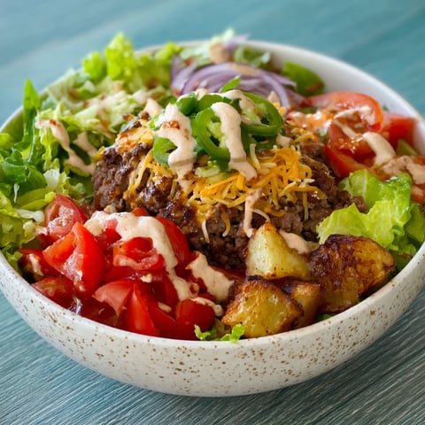 A bowl of Loaded Burger Bowls filled with various ingredients.