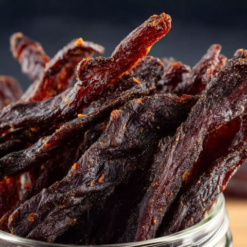 A jar filled with air fryer beef jerky, ready to be enjoyed.
