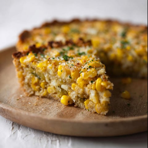 A slice of Mexican Street Corn Pie on a wooden cutting board.