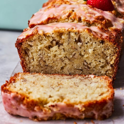 A slice of Strawberry Banana Bread with a strawberry on top.